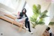 A woman sitting on a bed in a room.