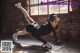 A woman doing push ups on a yoga mat.