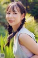 A young woman with long black hair smiling at the camera.